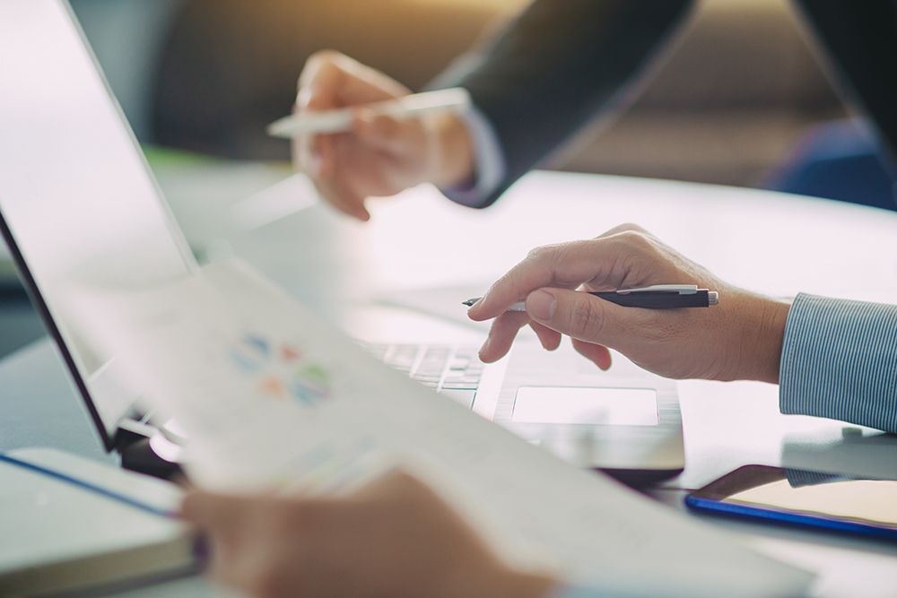 Two Businessman Analyzing Company Financial Report